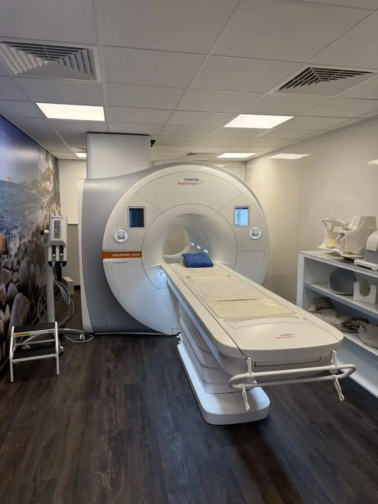Siemens MAGNETOM Amira 1.5T MRI system gantry and patient table in the exam room